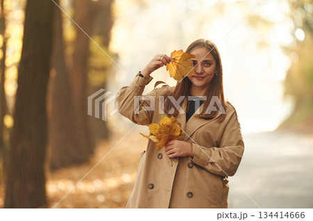 Happy woman is in the autumn forest Happy woman is in the autumn forest 134414666