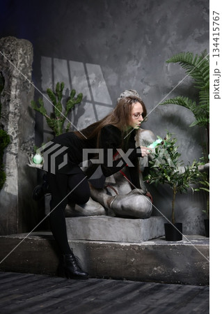 Female artist captures statue with intimate foliage background shot Female artist captures statue with intimate foliage background shot 134415767