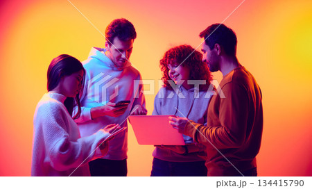 Business team collaborating across digital devices in neon light Business team collaborating across digital devices in neon light 134415790
