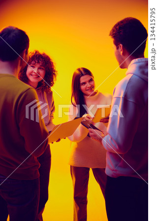 Business team reviewing documents on gadgets together. Business team reviewing documents on gadgets together. 134415795