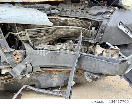 This minibus was significantly damaged as a result of a serious head-on collision. A seriously damaged grey minibus, which shows significant collision marks in the front and extensive rust marks. This minibus was significantly damaged as a result of a serious head-on collision. A seriously damaged grey minibus, which shows significant collision marks in the front and extensive rust marks. 134417709