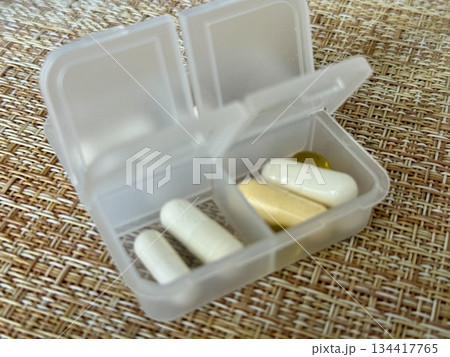 The weekly transparent pillbox is designed for convenient and efficient daily storage of dietary supplements and tablets. It has compartments with various types of capsules for administration. The weekly transparent pillbox is designed for convenient and efficient daily storage of dietary supplements and tablets. It has compartments with various types of capsules for administration. 134417765