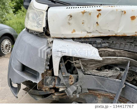 This minibus was significantly damaged as a result of a serious head-on collision. A seriously damaged grey minibus, which shows significant collision marks in the front and extensive rust marks. This minibus was significantly damaged as a result of a serious head-on collision. A seriously damaged grey minibus, which shows significant collision marks in the front and extensive rust marks. 134417767