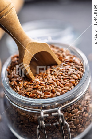 Linseed or flaxseed. Healthy flax seed in jar on black table. Linseed or flaxseed. Healthy flax seed in jar on black table. 134419260