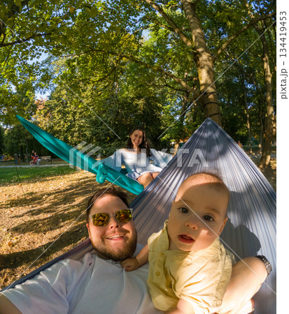 Family Relaxing in Park Hammocks Family Relaxing in Park Hammocks 134419453