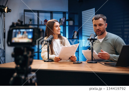 Tow people, together. Radio hosts recording podcast 134419792