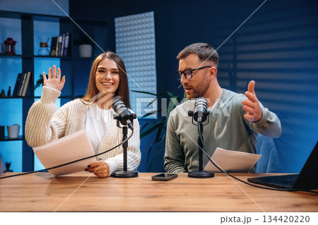 Microphones are on the table, talking. Radio hosts recording podcast 134420220
