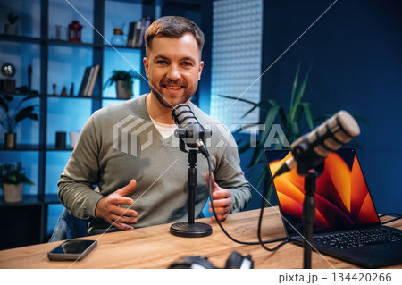 Man with microphone in the studio, conception of podcast Man with microphone in the studio, conception of podcast 134420266