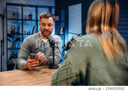 Active conversation. Radio hosts recording podcast 134420382