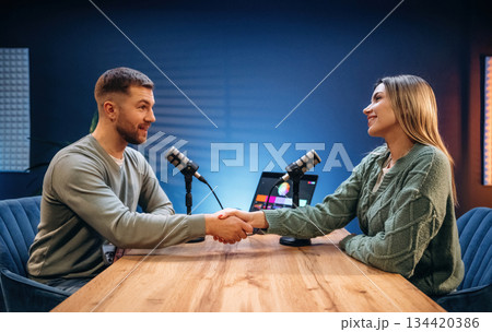 Making handshake. Radio hosts recording podcast 134420386
