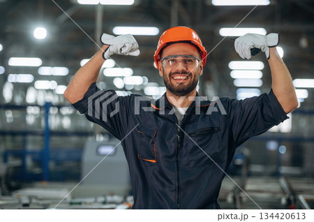 Strong, biceps, having fun. Man is working in the modern factory 134420613