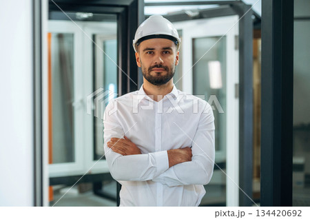 Standing with arms crossed. Man is working in the modern factory Standing with arms crossed. Man is working in the modern factory 134420692