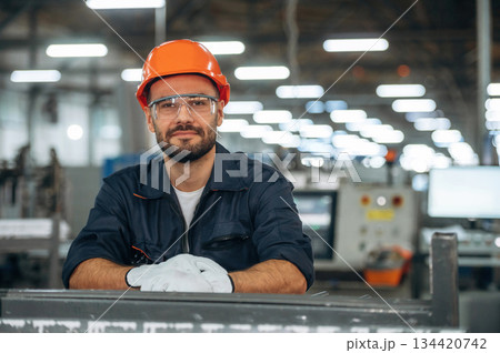 Professional mechanic or technician, standing. Man is working in the modern factory Professional mechanic or technician, standing. Man is working in the modern factory 134420742