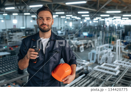 Break time, with fresh drink. Man is working in the modern factory Break time, with fresh drink. Man is working in the modern factory 134420775