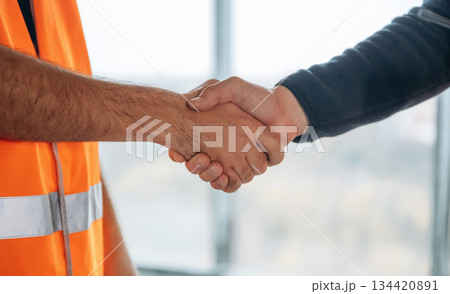 Close up view of two construction site workers making handshake, meet 134420891