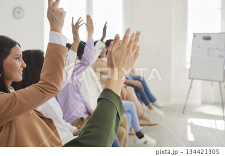Business women at the conference raising hands voting in the office. Business women at the conference raising hands voting in the office. 134421305