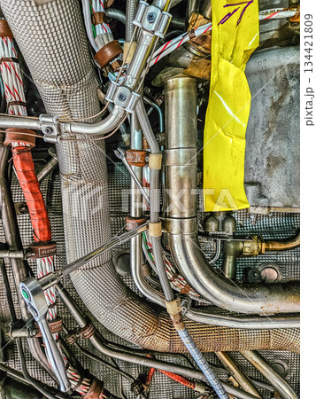 Detailed close-up of aircraft engine compartment with hydraulic pipes, cables and connectors. Aviation engineering and technical maintenance concept. High quality photo Detailed close-up of aircraft engine compartment with hydraulic pipes, cables and connectors. Aviation engineering and technical maintenance concept. High quality photo 134421809