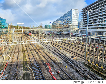 Complex network of railway tracks with modern trains and urban buildings near Geneva station, transportation infrastructure concept.. High quality photo 134421811