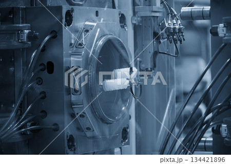 Close up scene material handling process the food container by robotic system from injection machine. Close up scene material handling process the food container by robotic system from injection machine. 134421896