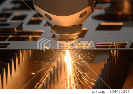 Close up scene the fiber laser cutting machine cut the metal plate control by CNC program. 134421897