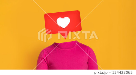 A vibrant yellow backdrop highlights a pink shirted figure with a speech bubble featuring a heart symbol. This illustration represents social media interaction and engagement. 134422063