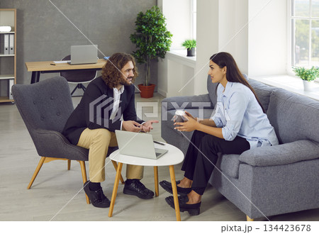 Young man and woman meeting in the office and talking about business cooperation Young man and woman meeting in the office and talking about business cooperation 134423678
