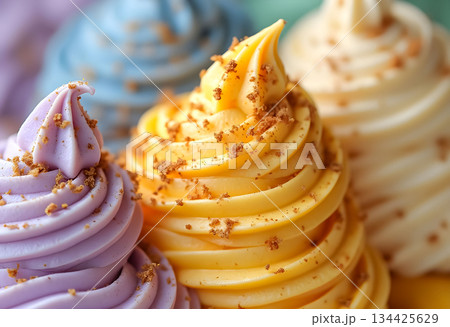 Colorful and creamy soft serve ice cream swirls topped with crunchy crumbs in a vibrant display at a dessert stand 134425629