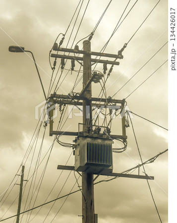 A pole mounted electricity stepdown transformer on an urban street A pole mounted electricity stepdown transformer on an urban street 134426017