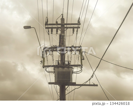 A pole mounted electricity stepdown transformer on an urban street A pole mounted electricity stepdown transformer on an urban street 134426018