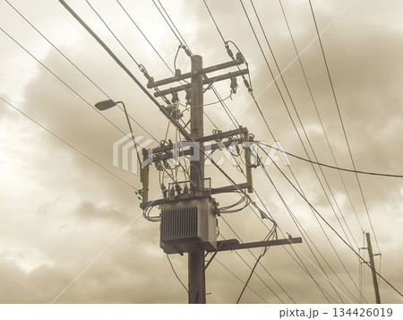 A pole mounted electricity stepdown transformer on an urban street A pole mounted electricity stepdown transformer on an urban street 134426019