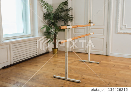 Empty ballet dance studio with barre. Professional ballet barre for stretching practicing dancing positions in dance school Dance hall ready for ballet class training. Ballet school 134426216