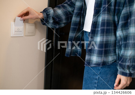 Close up picture of a woman opening the room in the hotel by security card 134426606