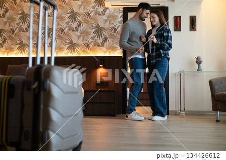 Happy couple in the hotel room feeling excited and enjoyed Happy couple in the hotel room feeling excited and enjoyed 134426612