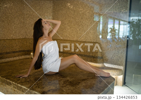 Long-haired pretty woman in spa center feeling wonderful 134426853