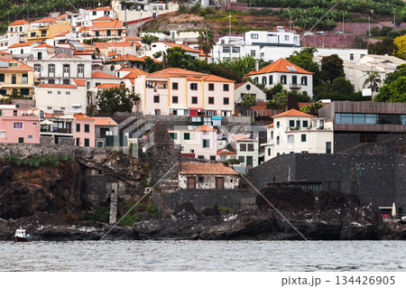 Madeira, vibrant seaside townscape of pastel and white houses with red roofs 134426905