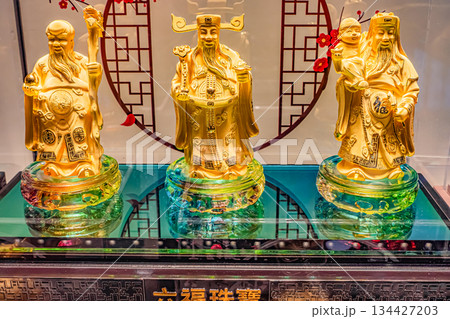 Golden Chinese deities figurines on display Golden Chinese deities figurines on display 134427203