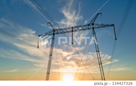 High voltage tower with electric power lines at sunset. Transmission of electricity High voltage tower with electric power lines at sunset. Transmission of electricity 134427326