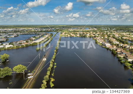 Flooded road with sunken car in surrounded with water Florida residential area. Consequences of hurricane Debby natural disaster Flooded road with sunken car in surrounded with water Florida residential area. Consequences of hurricane Debby natural disaster 134427369