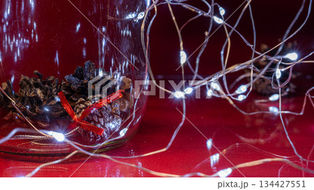 Christmas Pine Cones and Lights on Red Background 134427551