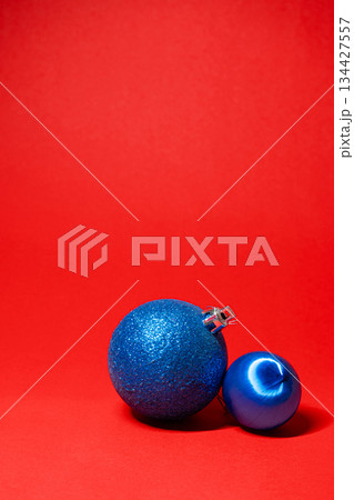 Elegant Blue Christmas Baubles on Bold Red Background Elegant Blue Christmas Baubles on Bold Red Background 134427557