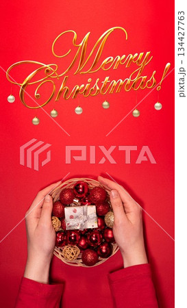 Christmas Basket with Red and Gold Decorations on Red Background Christmas Basket with Red and Gold Decorations on Red Background 134427763