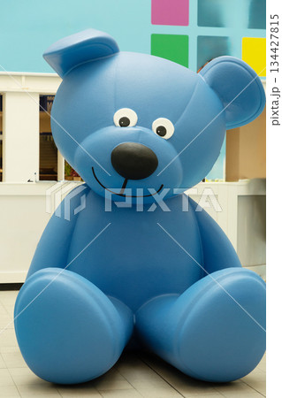 Berlin, Germany - September 09, 2025: Large blue teddy bear sitting in colorful room 134427815