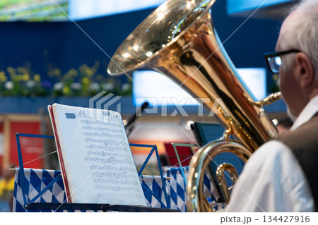 Berlin, Germany - January 22, 2024: Musician playing tuba with sheet music on stand 134427916