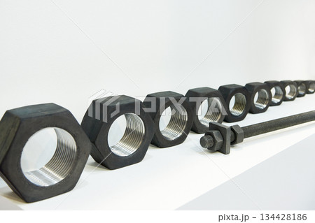 Row of metal nuts Row of metal nuts 134428186