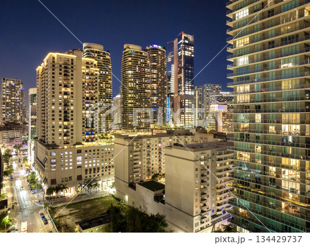 Downtown district of Miami in Florida, USA. Urban landscape of high skyscraper buildings in modern American city at sunset Downtown district of Miami in Florida, USA. Urban landscape of high skyscraper buildings in modern American city at sunset 134429737