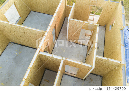 Construction of new and modern modular house. Walls made from composite wooden sip panels with styrofoam insulation inside. Building new frame of energy efficient home concept. 134429790