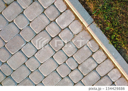 Close-up of slab stone paved path way at park or backyard. Walkway footpath road at house yard garden. Close-up of slab stone paved path way at park or backyard. Walkway footpath road at house yard garden. 134429886