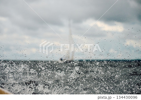 splashing water from under the boat, teamwork, Sailing regatta in the Gulf of Finland at cloudy day, sailing yacht competing in a race, splashing water from under the boat, teamwork, Sailing regatta in the Gulf of Finland at cloudy day, sailing yacht competing in a race, 134430096