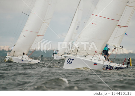 bow of a sailing boats with bowsprit at sailing regatta in the Gulf of Finland at sunny day, sailing yacht competing in a race, splashing water from under the boat, teamwork, board the boat bow of a sailing boats with bowsprit at sailing regatta in the Gulf of Finland at sunny day, sailing yacht competing in a race, splashing water from under the boat, teamwork, board the boat 134430133