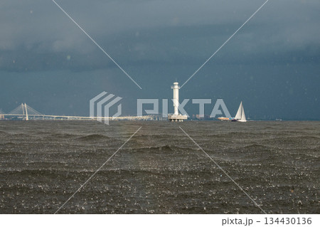 Sailing regatta in the Gulf of Finland in heavily rain, few sailing yachts competing in a race, splashing water from under the boats, teamwork, board the boat 134430136